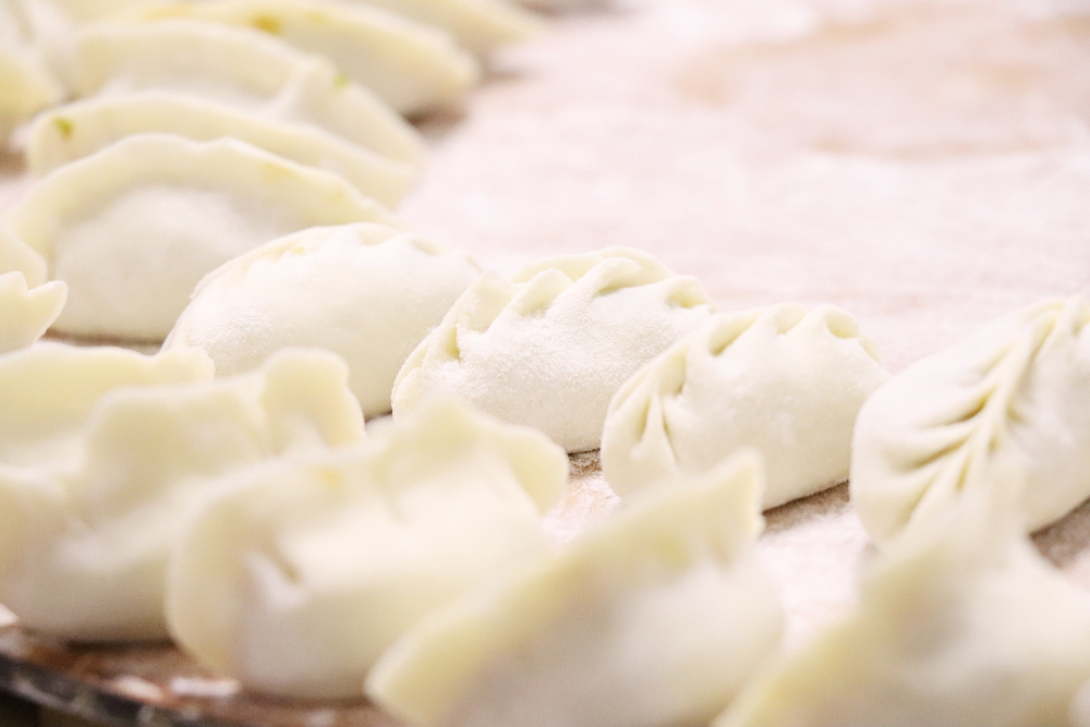 Freshly wrapped jiaozi, or as they are better known in English Translation, Chinese dumplings